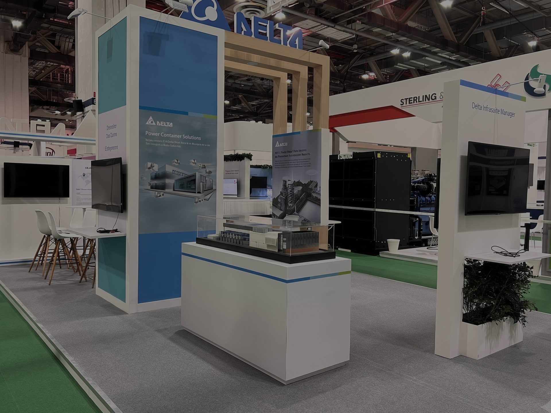Delta Electronics exhibition stand on the show floor, with a Legion-built scale model displayed in a glass case