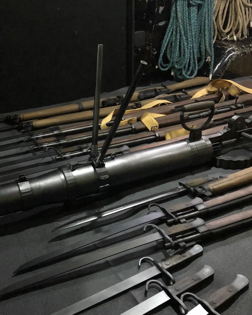 A dark spread of hand-finished WWII rifle, bayonet and machine-gun replicas for the Reflections at Bukit Chandu gallery